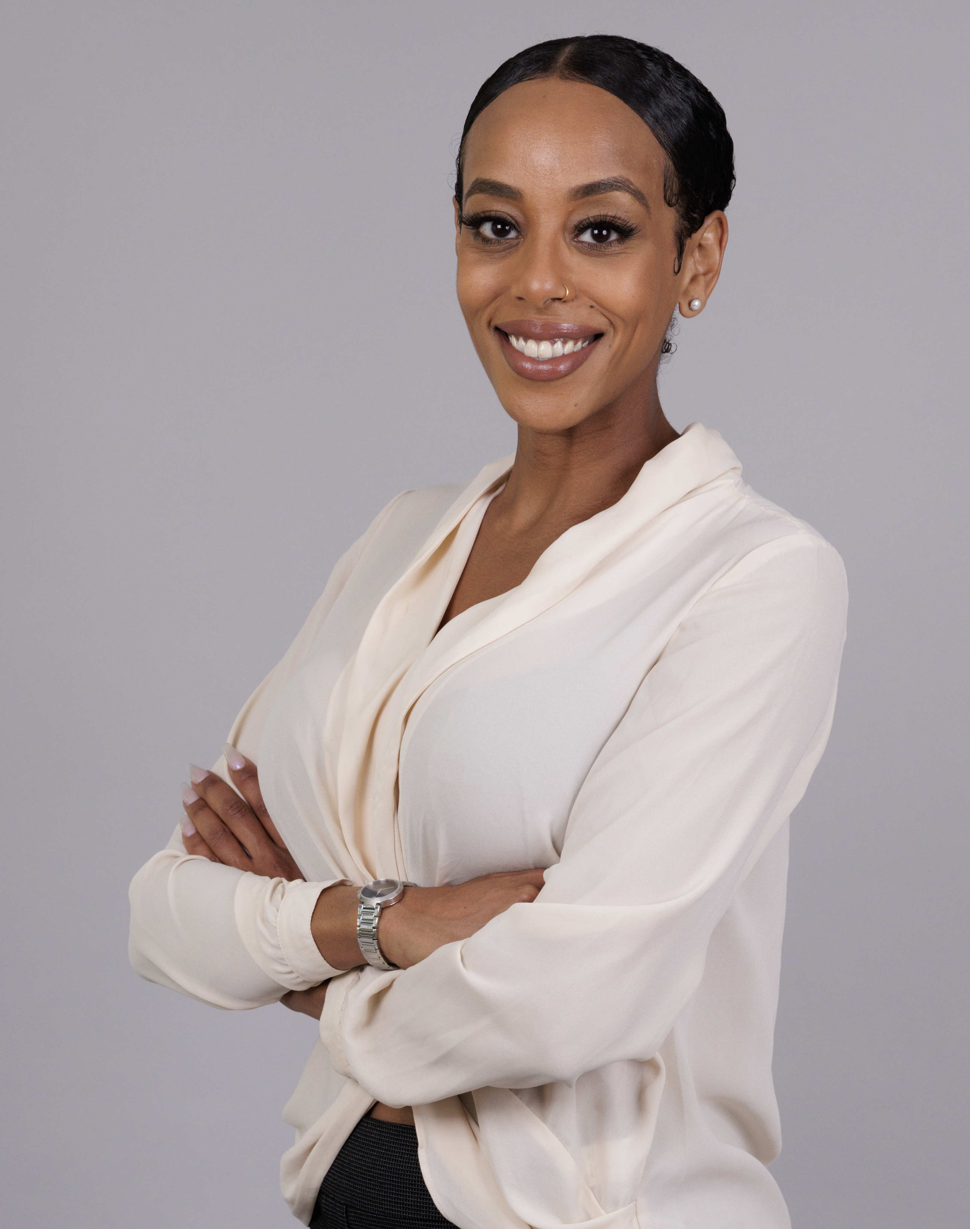 Sewit Tamene in her original cream blouse portrait, arms crossed